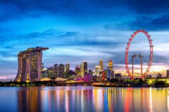 Singapore skyline with Marina Bay Sands and Ferris wheel at dusk.